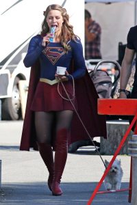 Melissa Benoist eating an icy and walking her dog.jpg